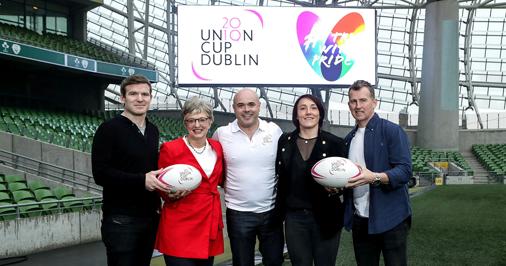 The Union Cup 2019 launch in the Aviva Stadium with Nigel Owens, Lindsay Peat, Katherine Zappone and two men posing on the pitch with rugby balls