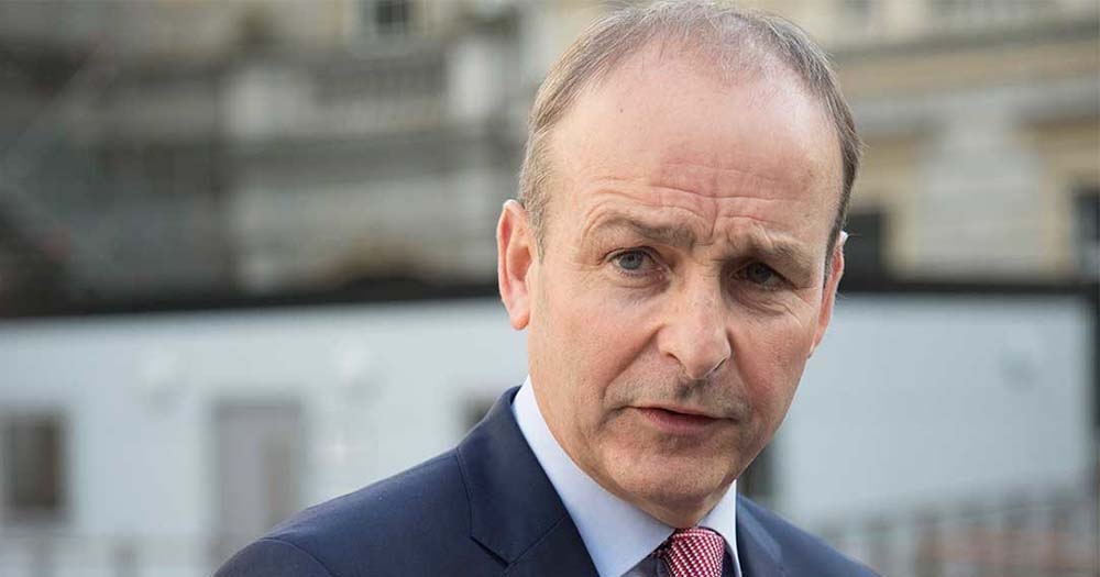 Micheál Martin dressed in a suit speaking to the camera