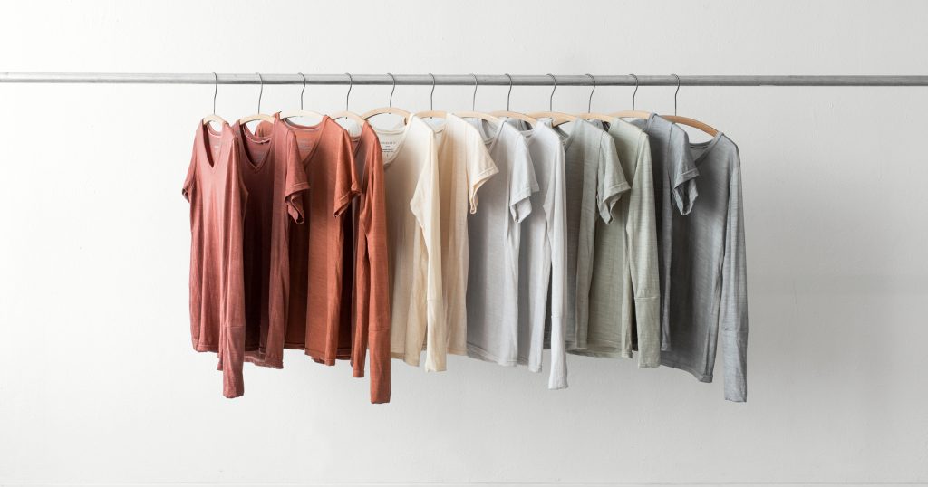 A clothes rack with second-hand clothes hanging in a slow fashion store