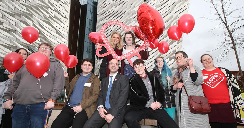 Love Equality campaigners hold heart shaped balloons and banners