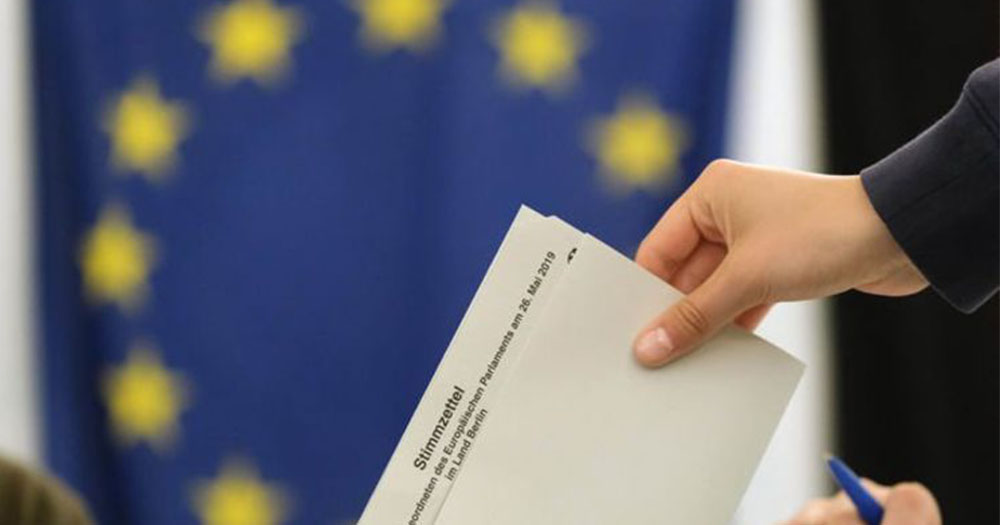 Submitting a vote against a background of the EU flag following the rise of the alt-right