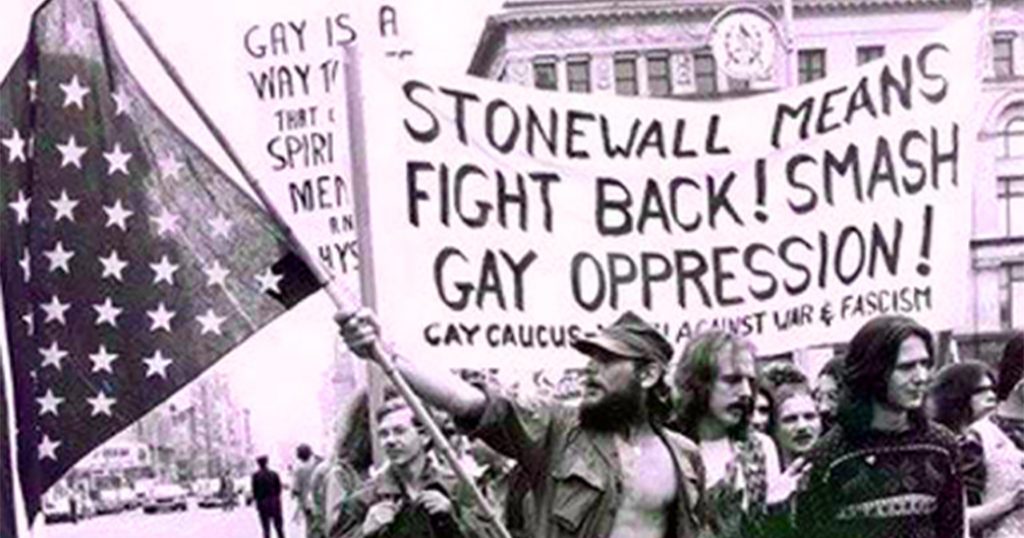 Protestors holding a banner that reads " Stonewall means fight back! Smash gay oppression!"