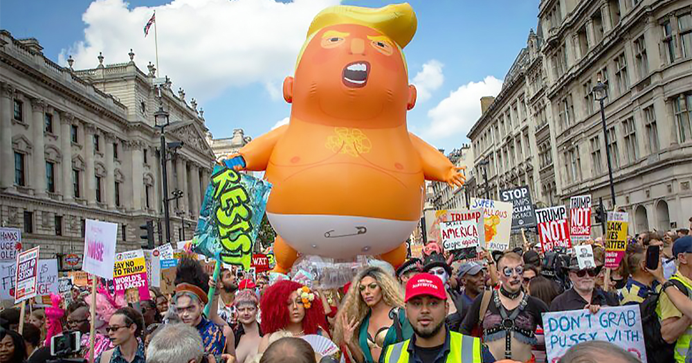 A giant blimp of a baby Donald Trump towers over a marching crowd. This will be displayed at the Dublin Trump protest.