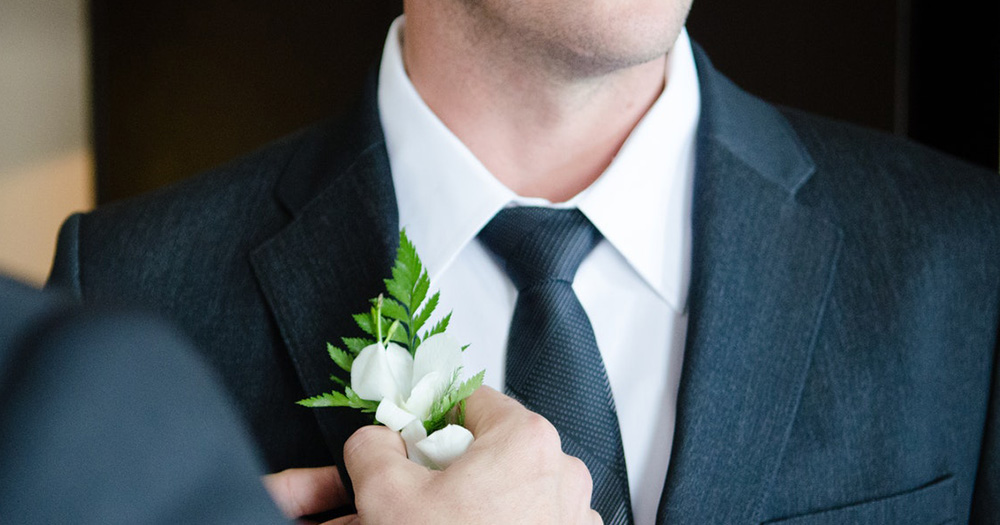 Campaigners hopeful of a January 2020 deadline for same-sex marriage in Northern Ireland Fixing the corsage on a man's suit in preparation for a wedding.