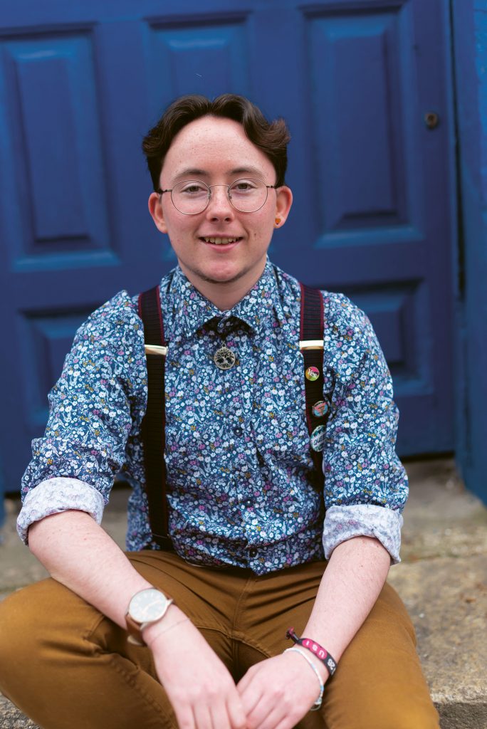 Man sitting on steps: in this piece queer people describe the difficulties of a simple trip to the barbershop