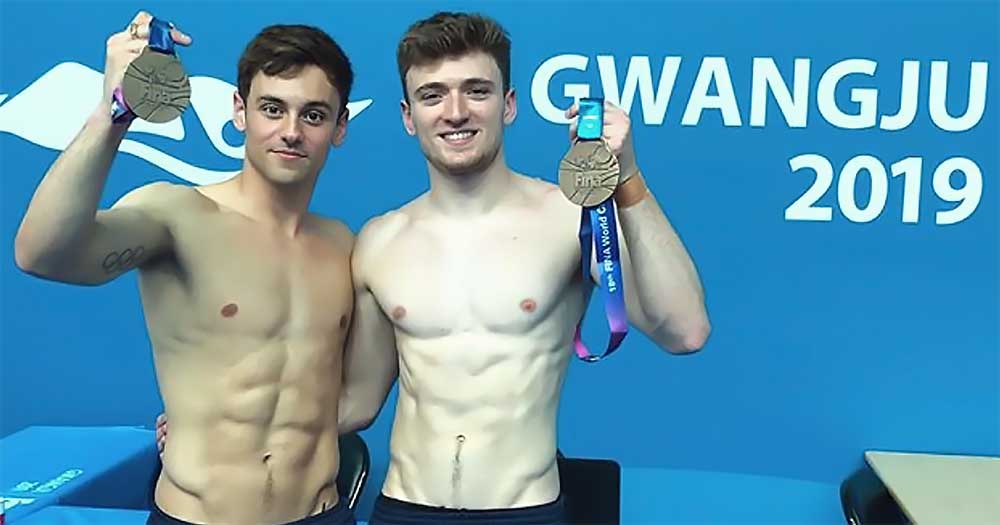 Tom Daley and Matty Lee holding bronze medals in the world championships in korea