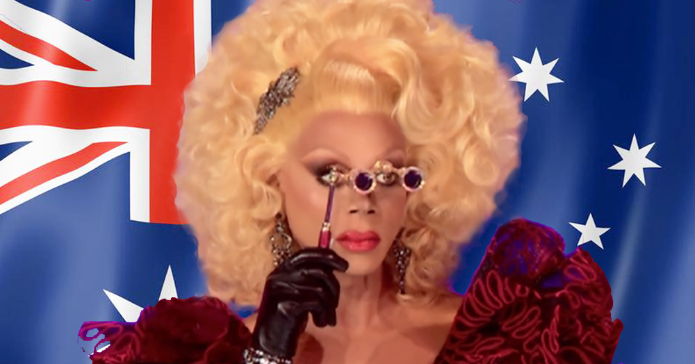 RuPaul holding a monocle, behind her the Australian flag. Drag Race Australia has just been confirmed