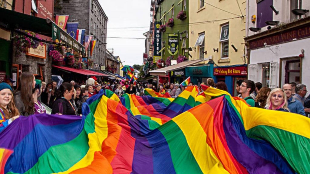 People holding a Pride flag at Galway Pride Parade