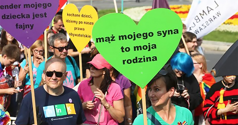 Family and members of LGBT+ community holding heart signs in Poland. Recently Polish newspaper Gazeta Polska has come under fire for distributing anti-LGBT stickers