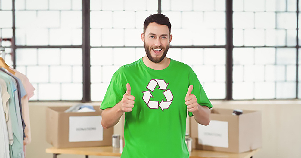 Man wearing recycling t-shirt doing double thumbs up