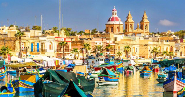 One of the top LGBT+ friendly destinations - a view of boats and Malta's cathedral