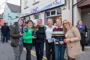 Six smiling women standing outside the LINC building in Cork