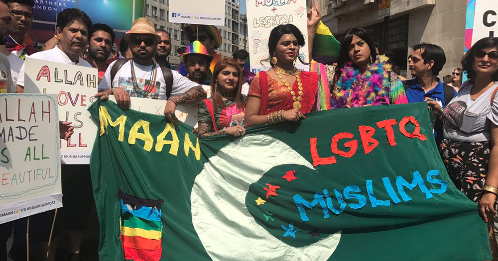 Members of Imaan holding a banner with a crescent moon and the words "Imaan LGBTQ Muslim"