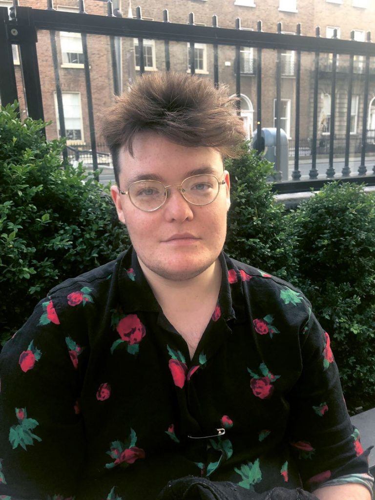 Portrait photo of trans man Ezra Maloney who opens up about his transition