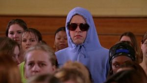 DIY halloween costume ideas: Tall teenage boy wearing blue hoodie and sunglasses stands a foot above crowd of teenage girls