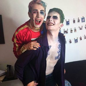 Two men dressed up in Harley and Joker Halloween costumes