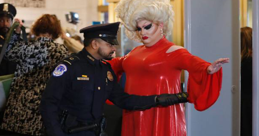 Drag queen Pissi Myles being searched by security before entering the impeachment hearings