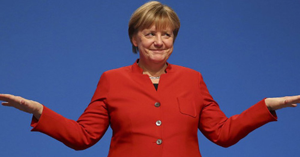 Chancellor Angela Merkel smiling and wearing a red suit, Germany has just passed a draft bill banning "conversion therapy"