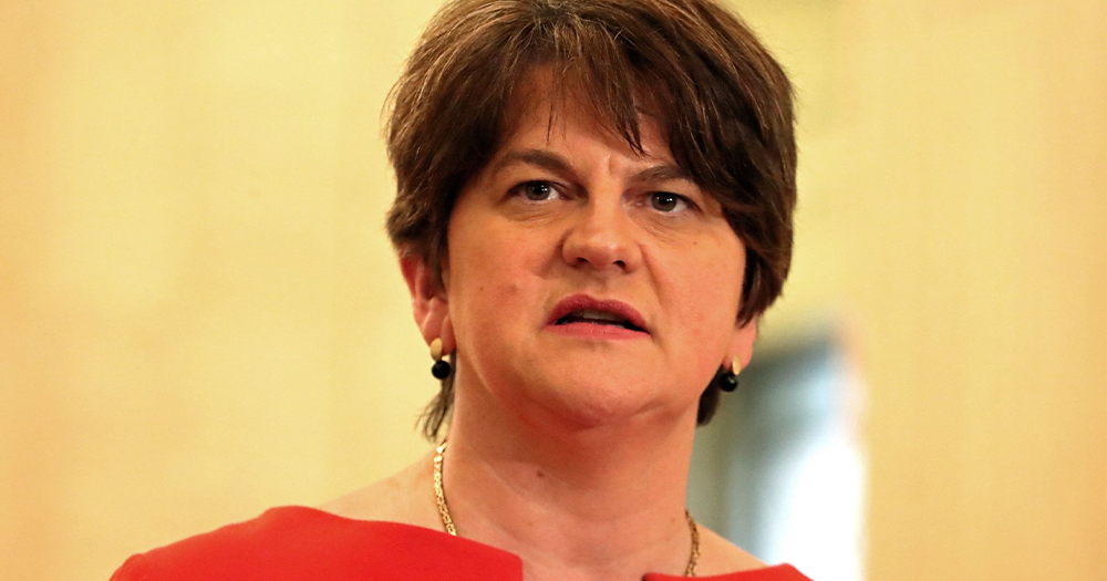 Arlene Foster, a middle aged woman with short hair wearing a fancy dress about to speak at an event