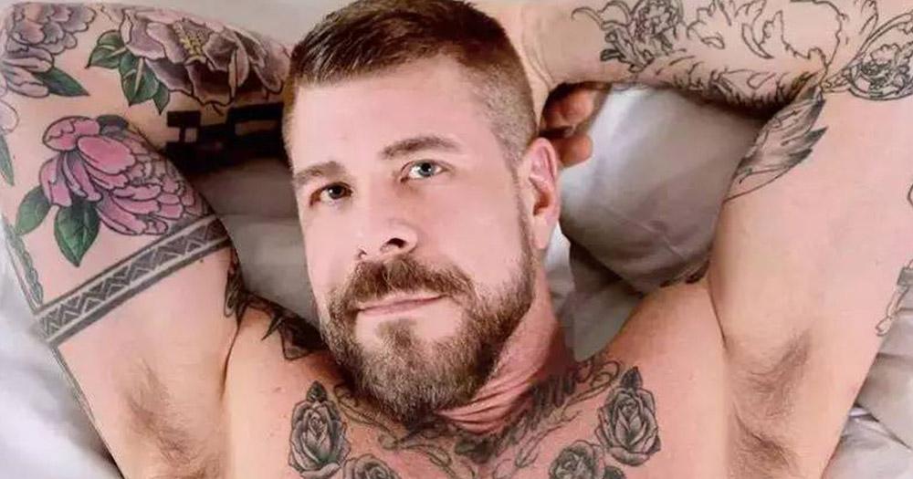 Gay adult performer Rocco Steele lying shirtless on a bed.