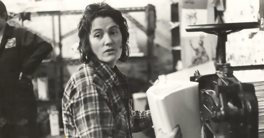 Black and white photo of gay Liberation movement activist Luchia Fitzgerald wearing a checkered shirt