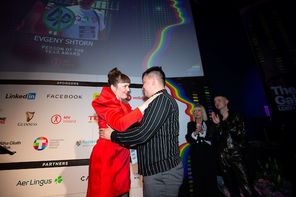 woman on stage embracing man 