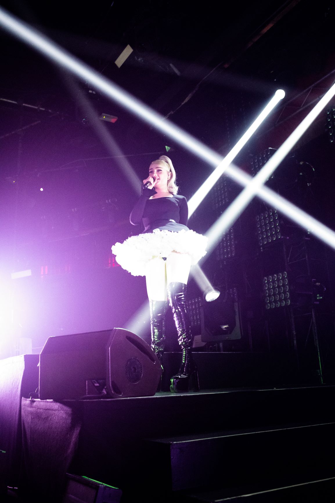 White beams of light shining on Kim Petras. Images by Babs Daly