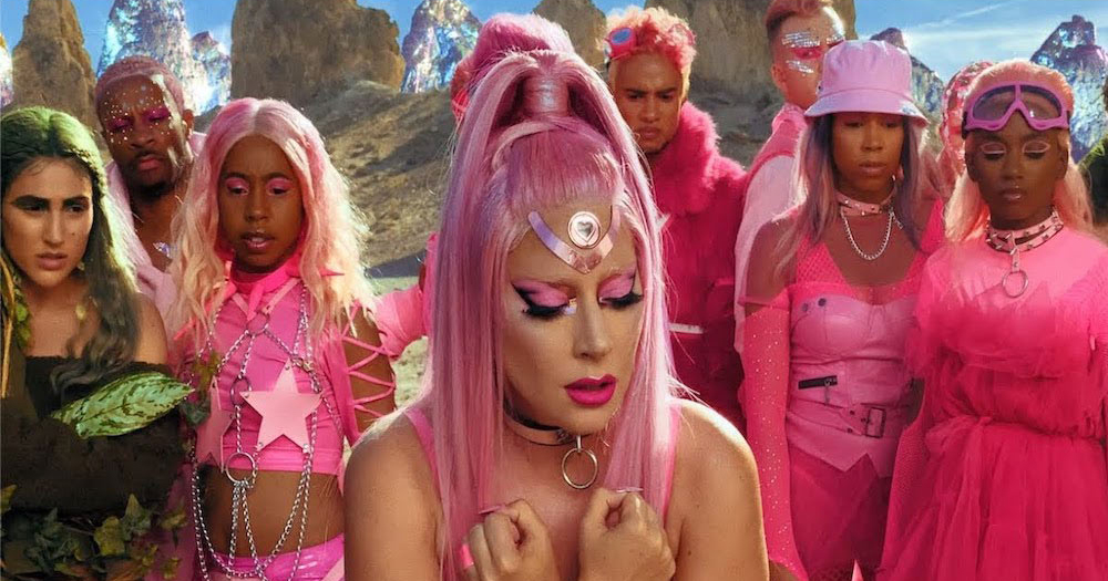 Lady Gaga dressed in pink alongside actors for her music video Stupid Love