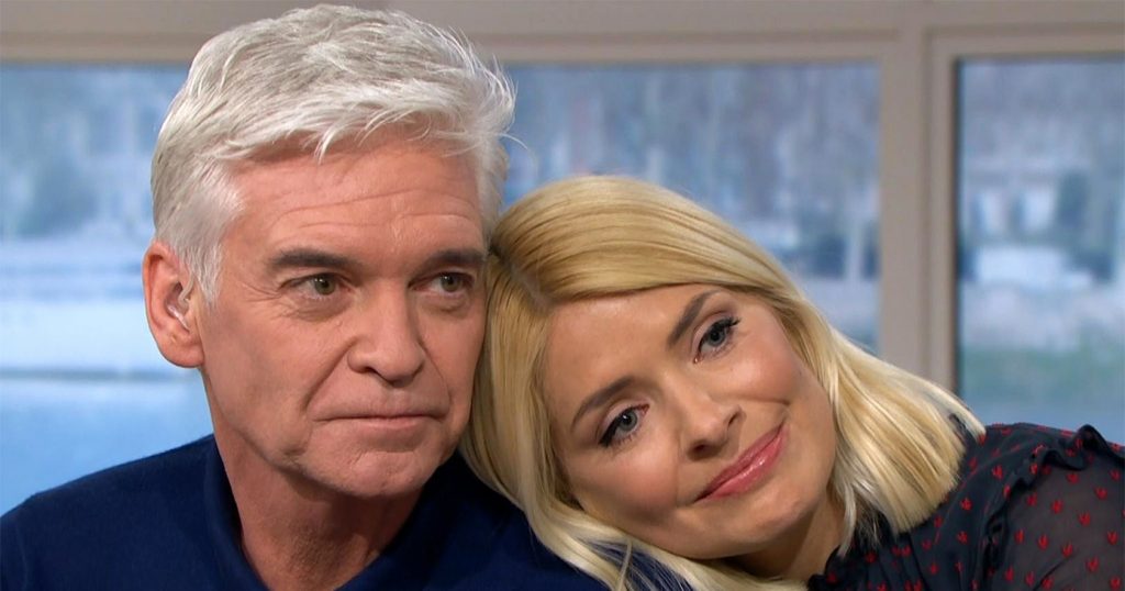 Close up of Phillip Schofield and Holly Willoughby. Holly is resting her head of Philip's shoulder