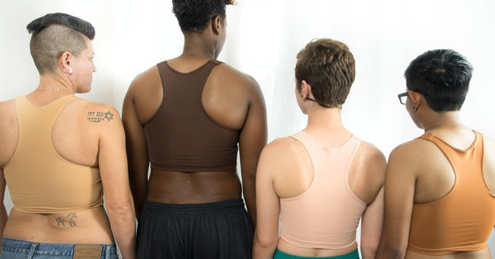 A group of four people of different races seen from behind wearing chest binders