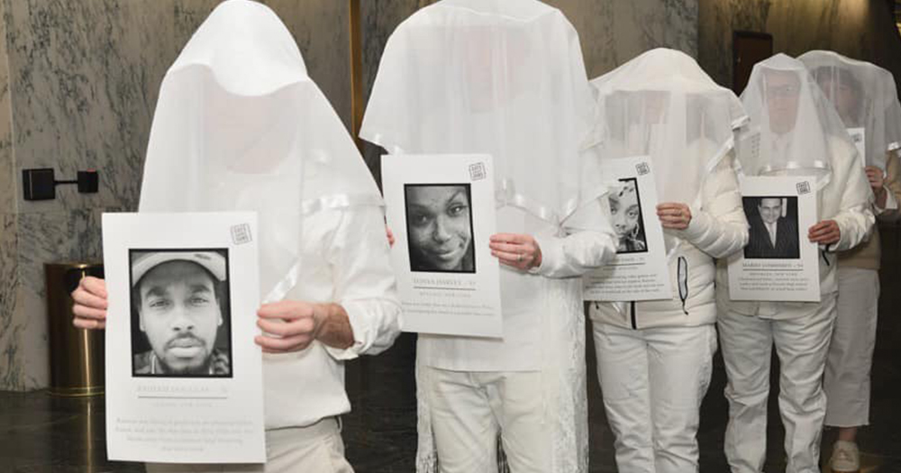 Members of Gays Against Guns (GAG) dressed in white and veiled holding space or those killed by gun violence