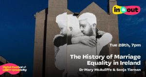 A huge artwork of two men embracing pasted onto the side of a building