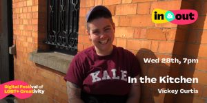 A smiling woman in a cap leans against the side of a building