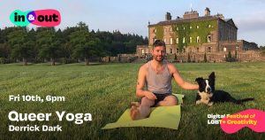 A bearded man in yoga gear sits beside a dog on a blanket in a field by a castle