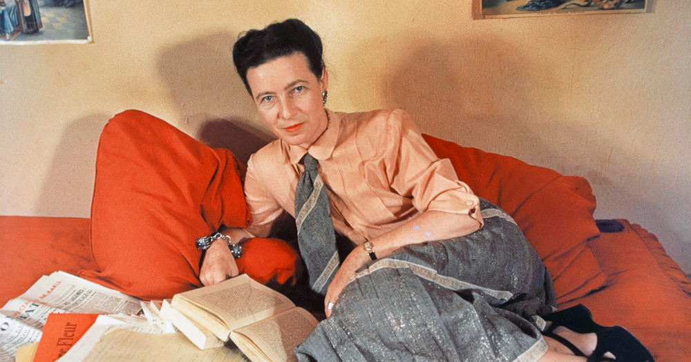 Simone de Beauvoir lying on a bed with a novel, her previously unpublished book will finally be released later this year