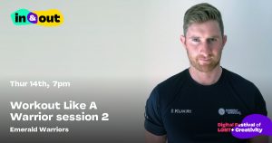 A serious looking bearded man in a rugby top stares straight into the camera
