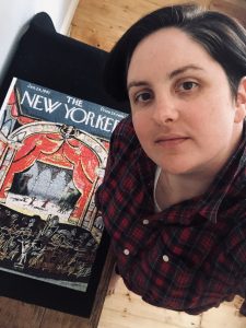 A dark haired woman takes an overhead selfie alongside her jigsaw