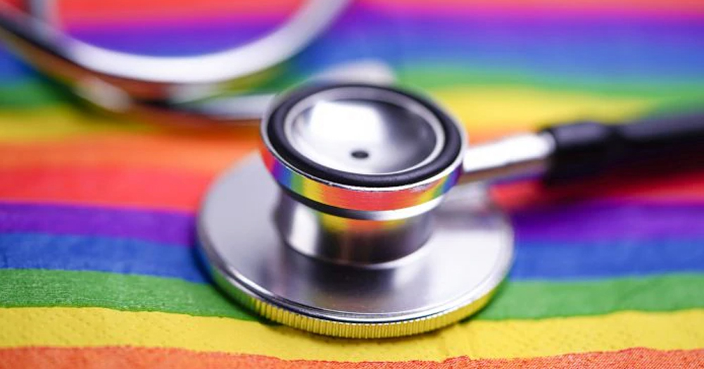 A stethoscope lying on a rainbow flag