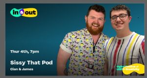 Two colourfully dressed young men smile at the camera