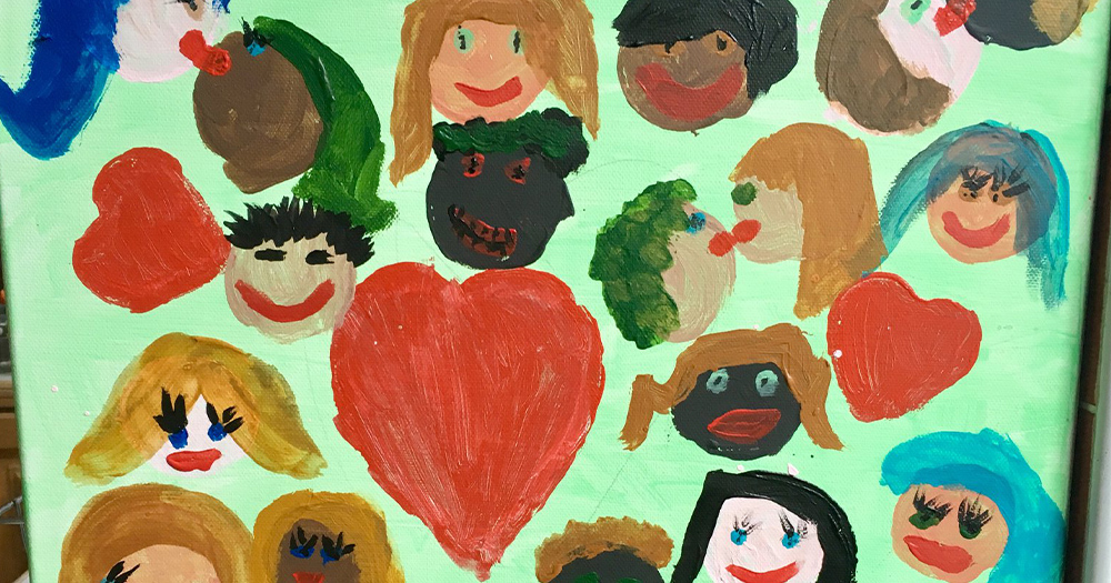 A child's painting of lots of different faces with a big love heart in the middle