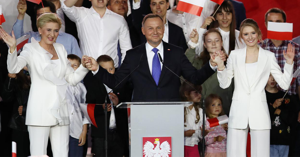 Andrzej Duda, a middle aged smiling man being elected President surrounded by supporters