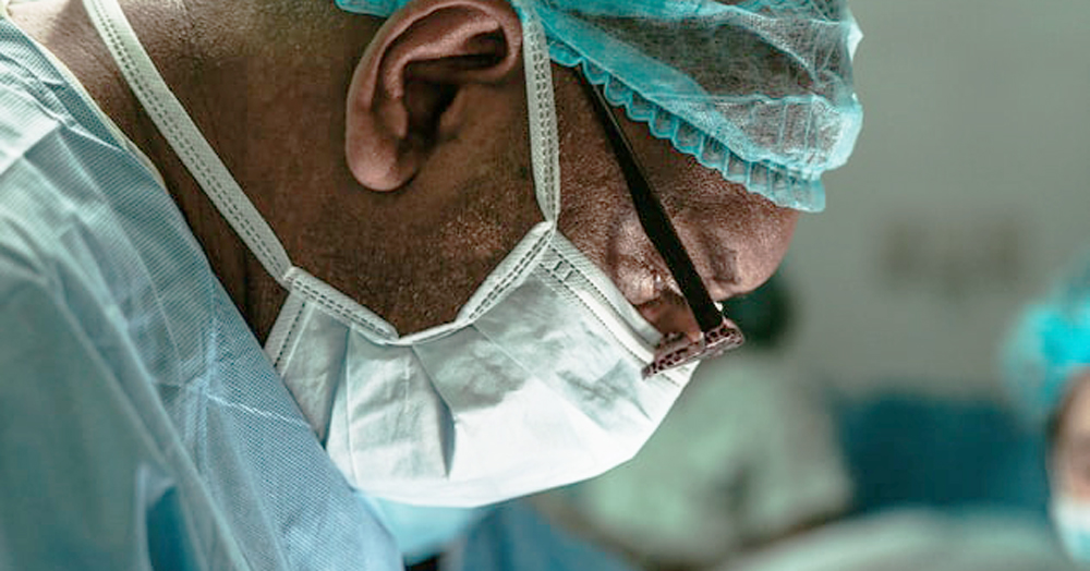 An Italian surgeon has been suspended following accusations of homophobic comments, image shows a person in surgery wearing a mask and blue robes