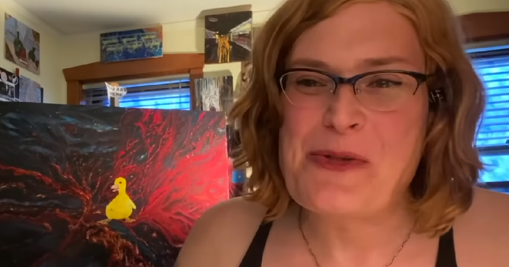 Lilly Wachowski smiling as she speaks to Netflix via webcam in from her home studio