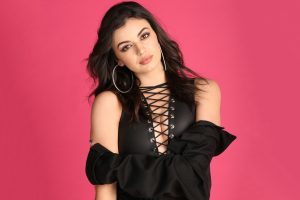 A young woman wearing a lace up top