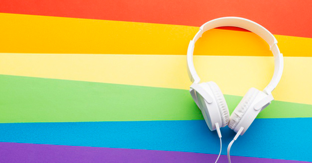 Queer podcasts: white headphones against a rainbow coloured background