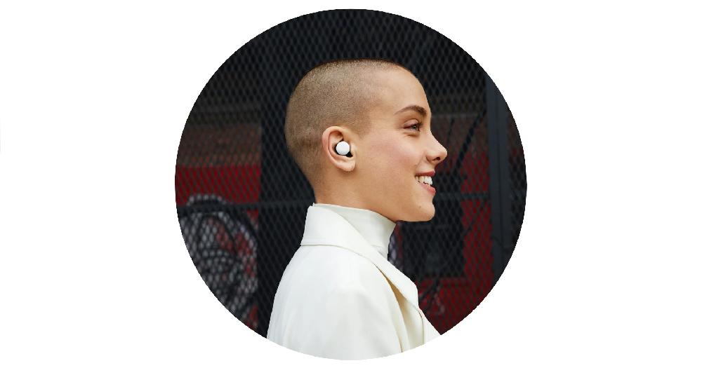image of a person with a shaved head wearing the google pixel earbuds