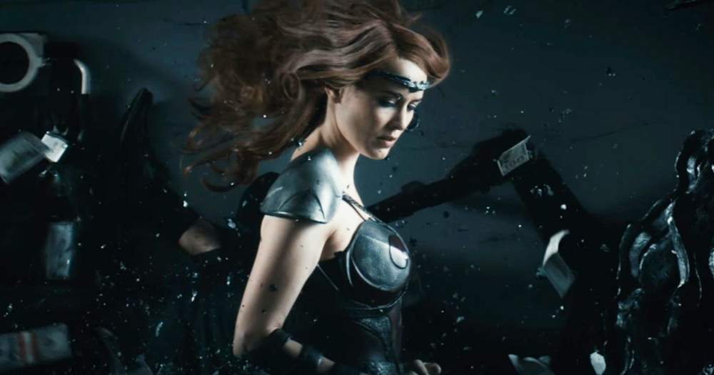 A female superhero walks through a battle
