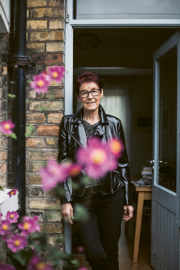 life in lockdown feature portrait of woman standing at her door