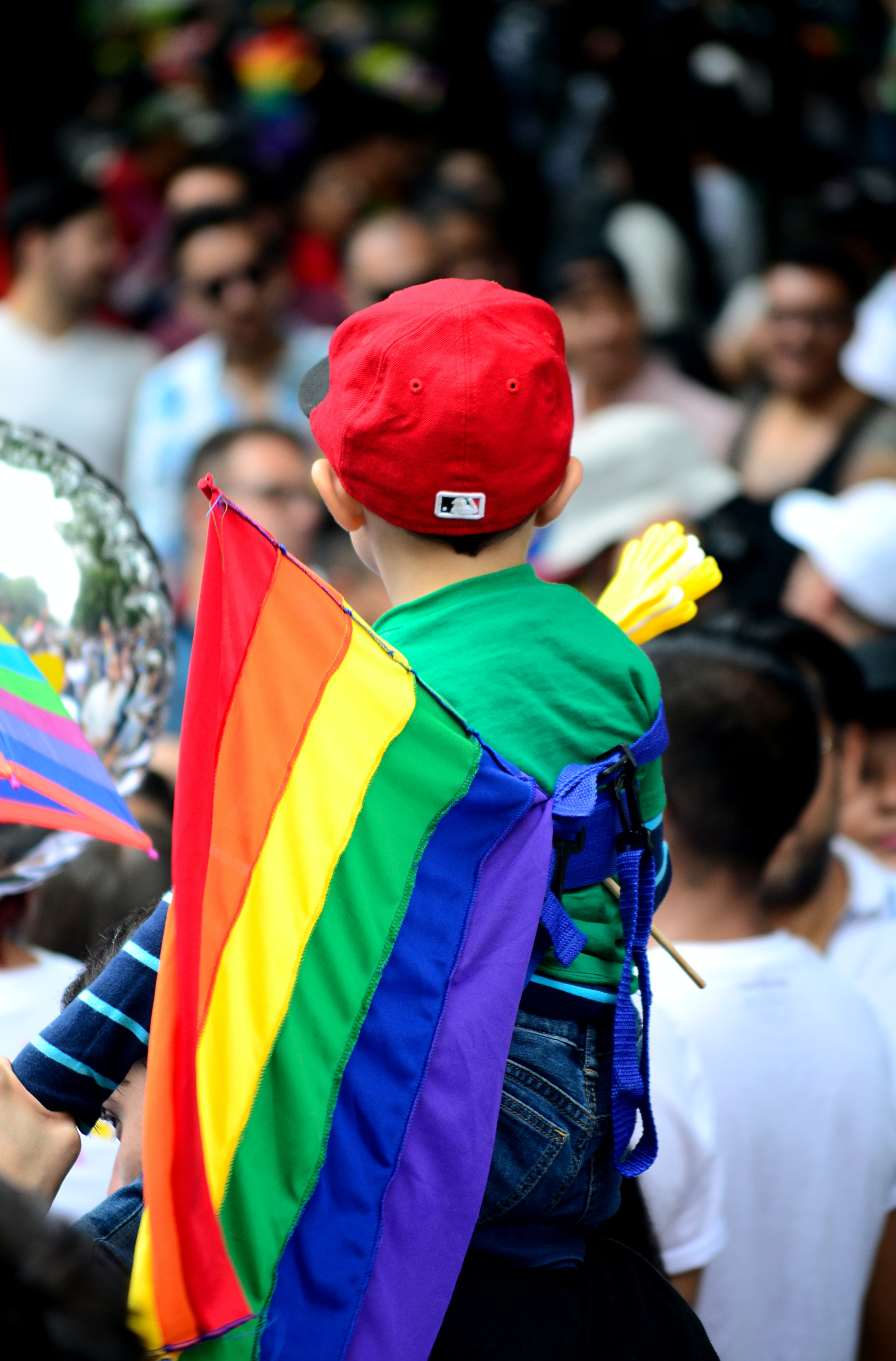 Little boy holding pride flag