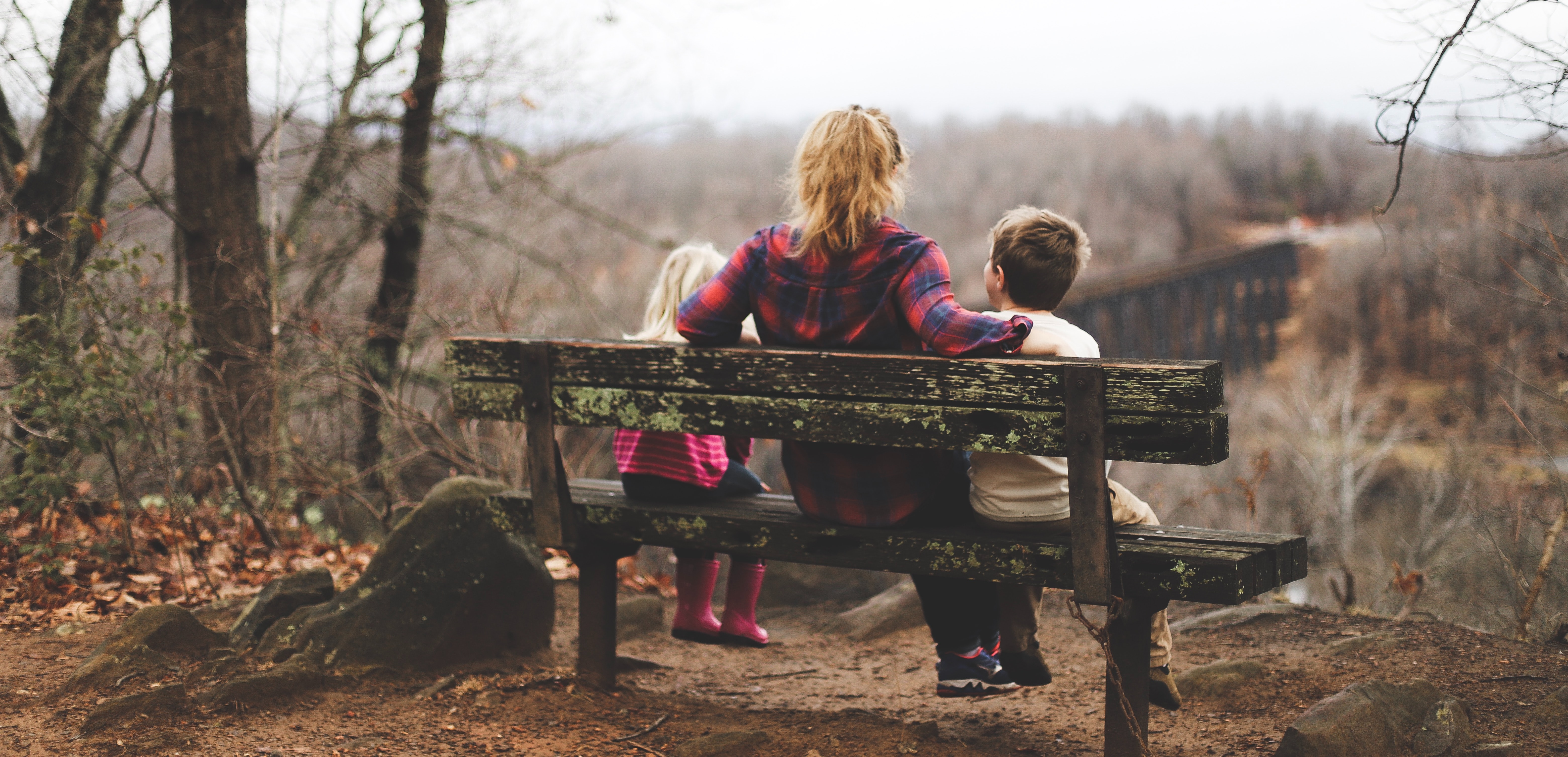 Mother sitting with her children on a bench
